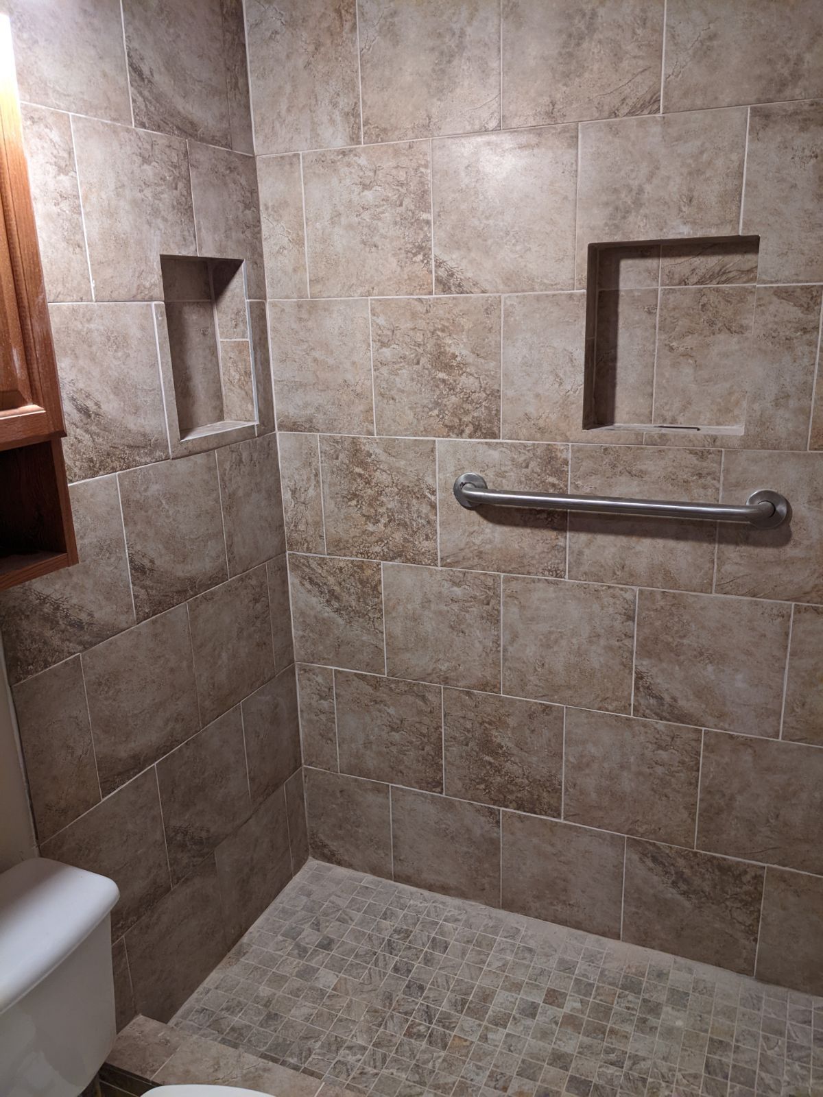 A bathroom with a walk in shower and a toilet.