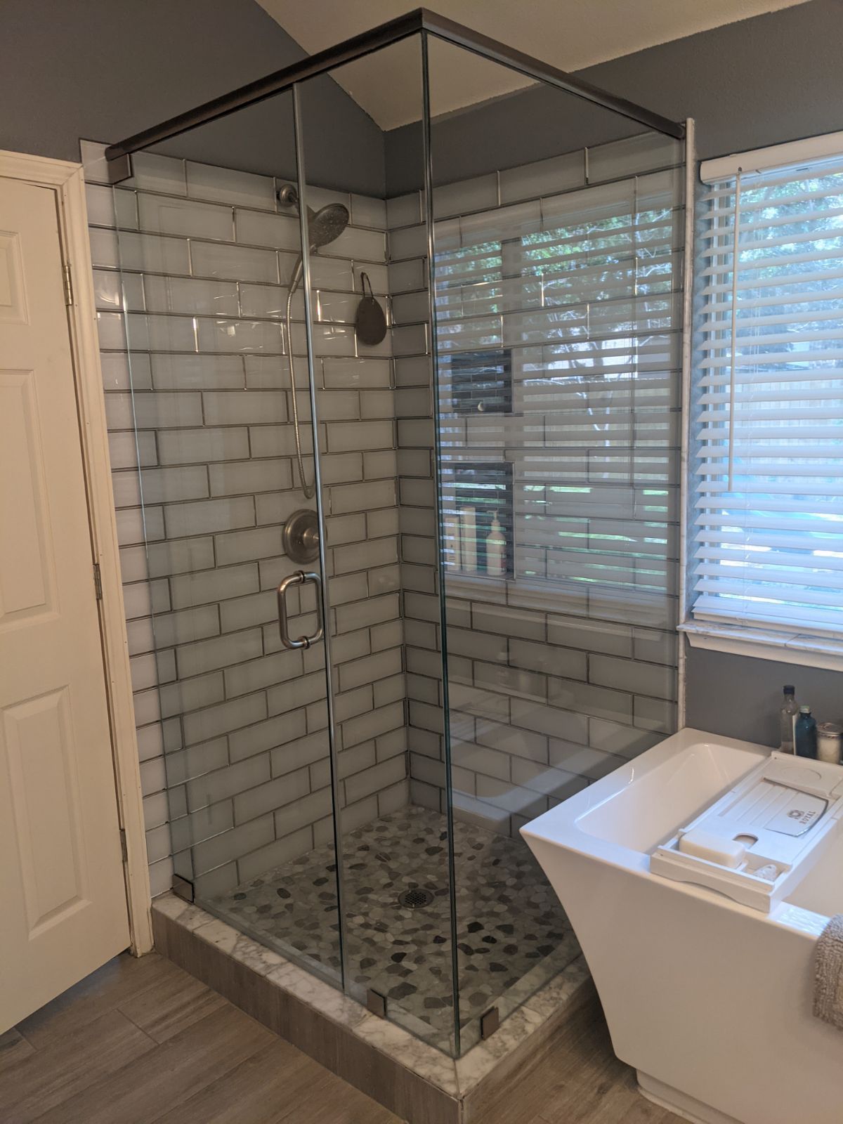 A bathroom with a walk in shower and a bathtub.