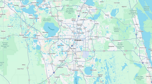 Map with roads and waterways showing a city area and surrounding lakes, centered on an urban grid.