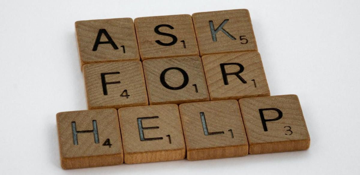 Scrabble tiles with the words ask for help written on them Scrabble tiles with the words ask for help written on them