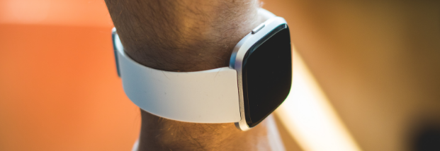 A person is wearing a smart watch on their wrist. A person is wearing a smart watch on their wrist.
