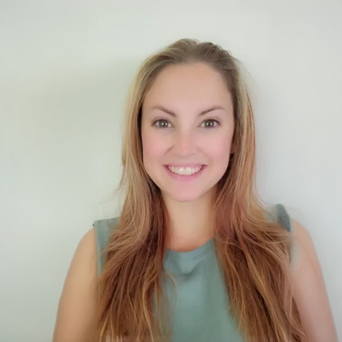 A woman with long hair is smiling for the camera. A woman with long hair is smiling for the camera.