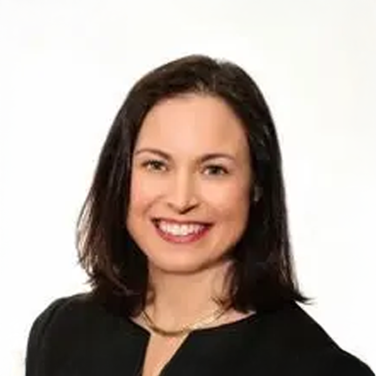A woman in a black shirt is smiling for the camera. A woman in a black shirt is smiling for the camera.
