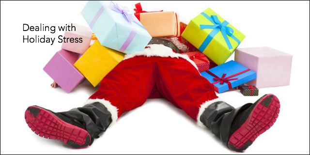 Santa claus is laying on the ground surrounded by gifts and says dealing with holiday stress