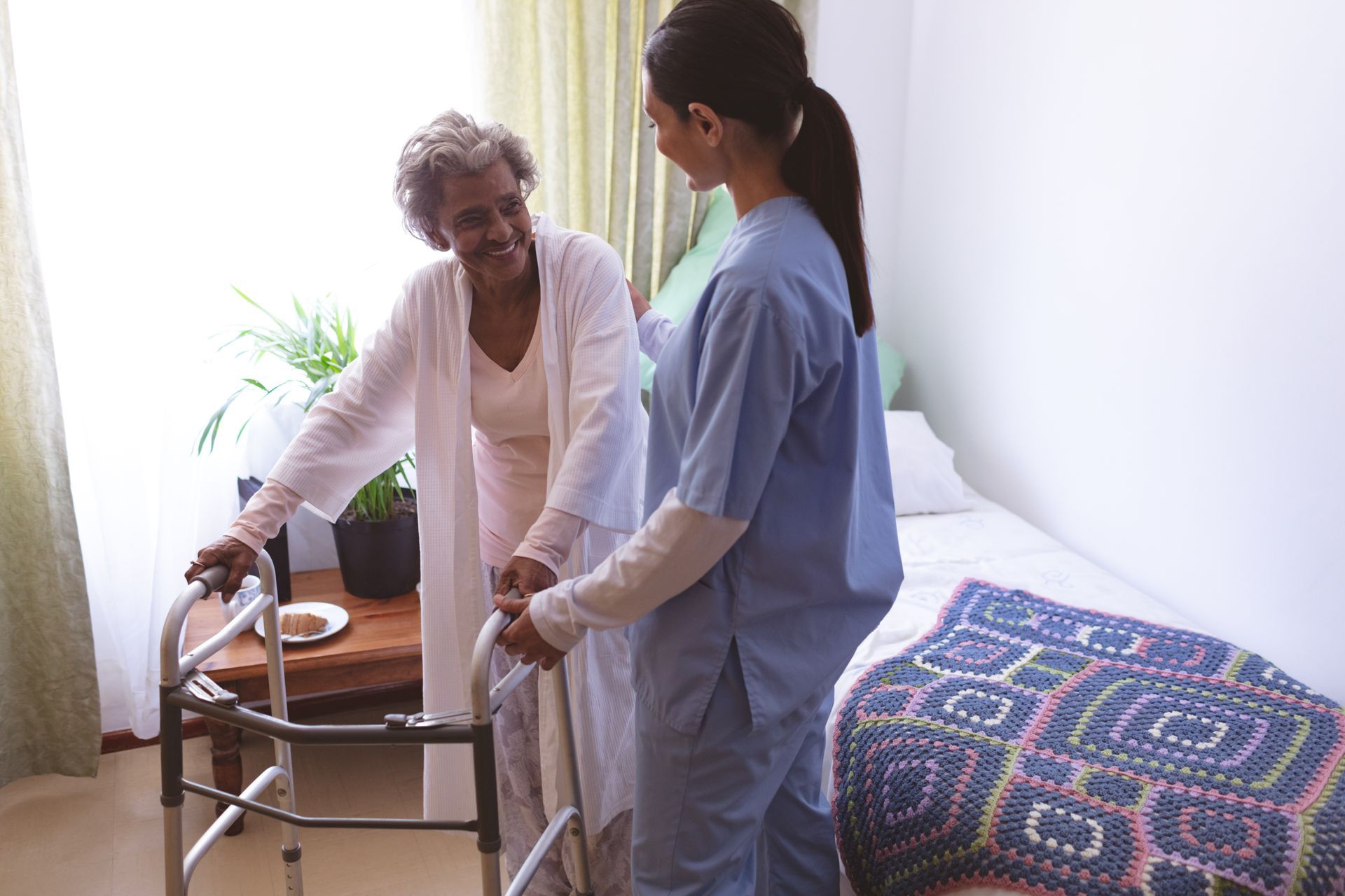 female nurse helping senior