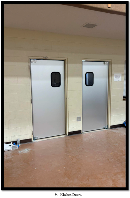 Two new silver industrial doors to the kitchen in the family life center.