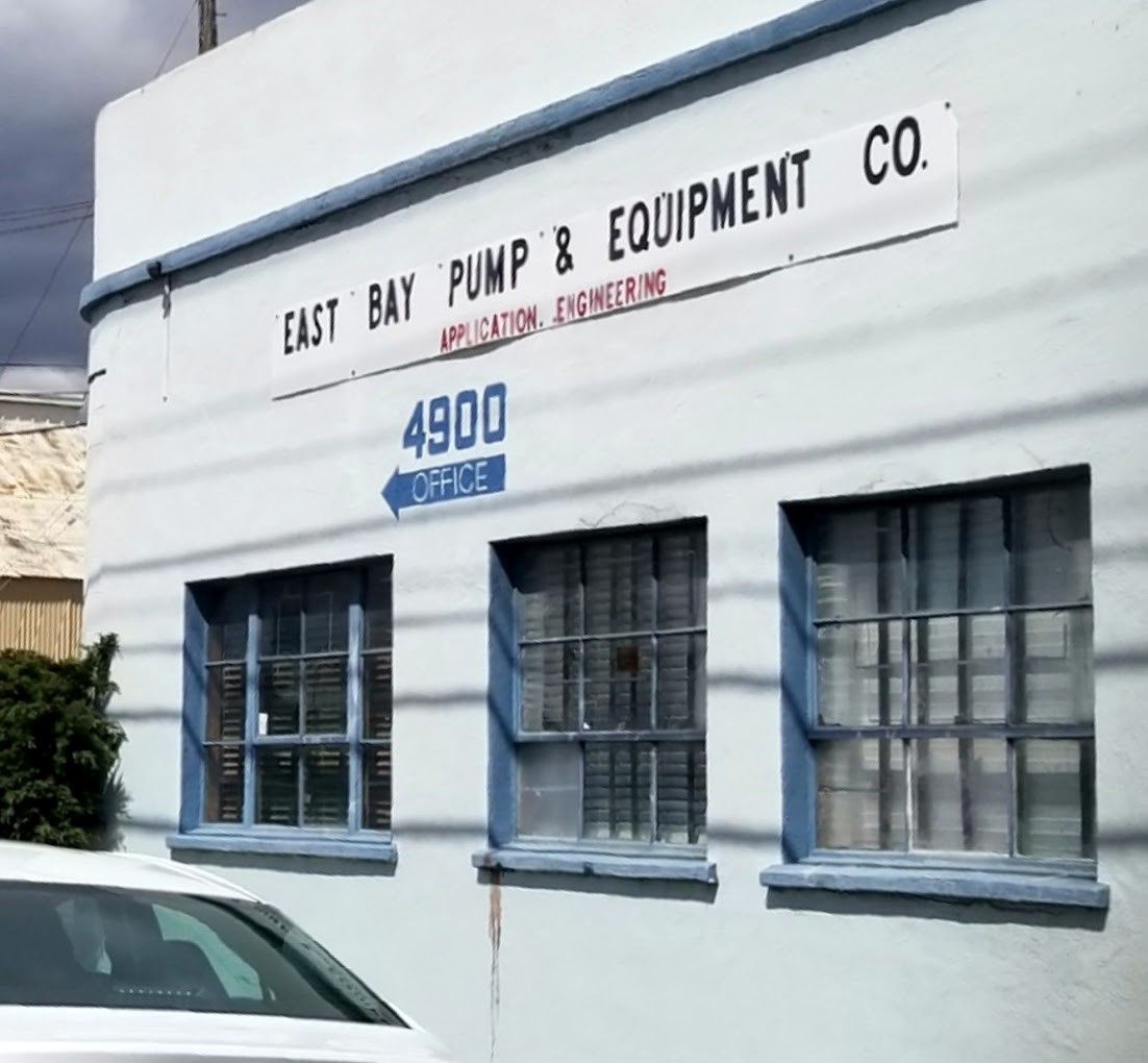 A swimming pool pump is sitting inside of a shed.