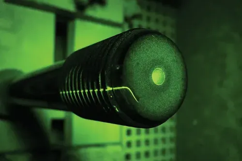 A close up of a green object with a hole in the middle.