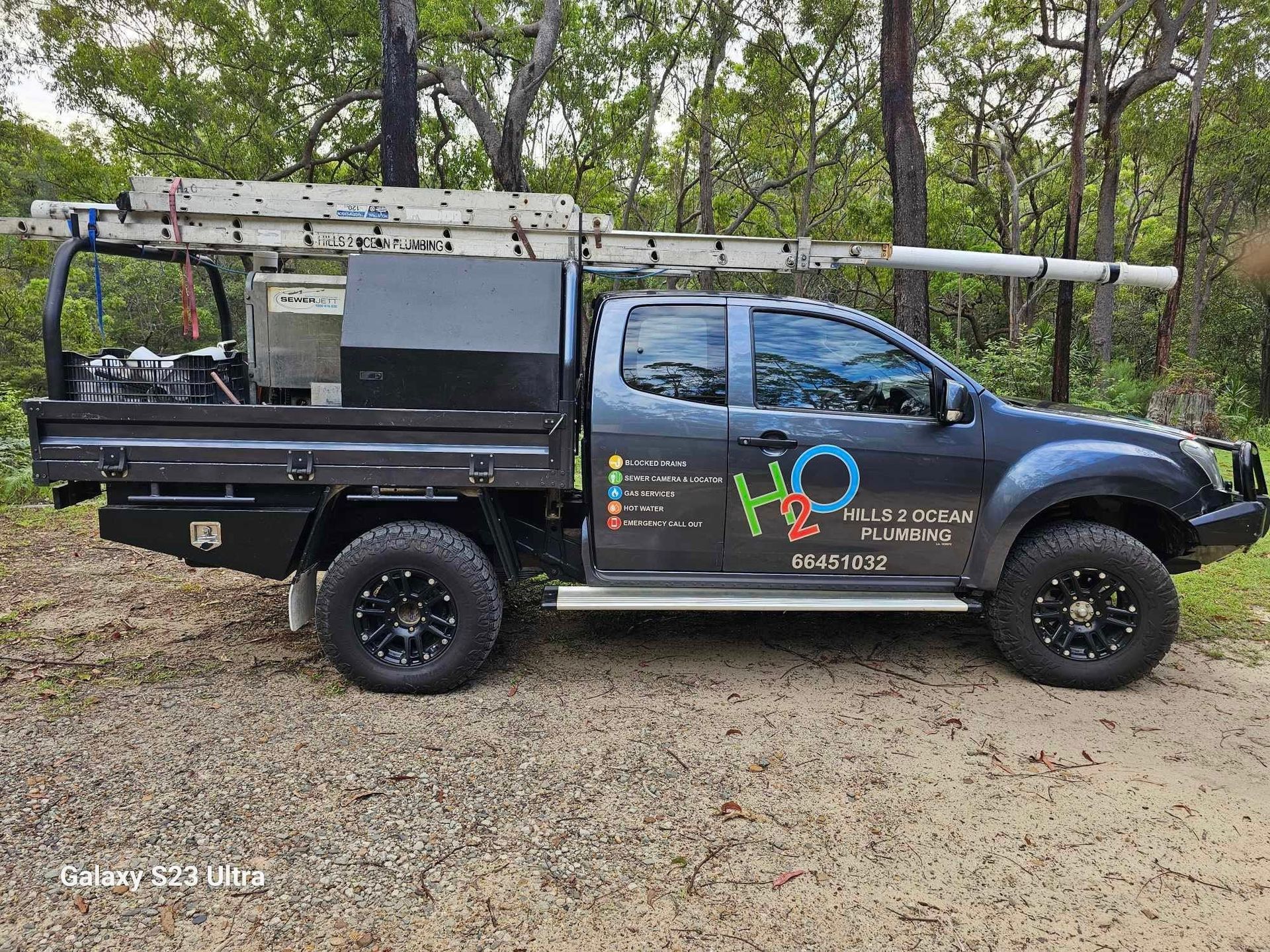 Dark Gray Work Truck with Ladder, Pipes — Hills 2 Ocean Plumbing in Maclean, NSW