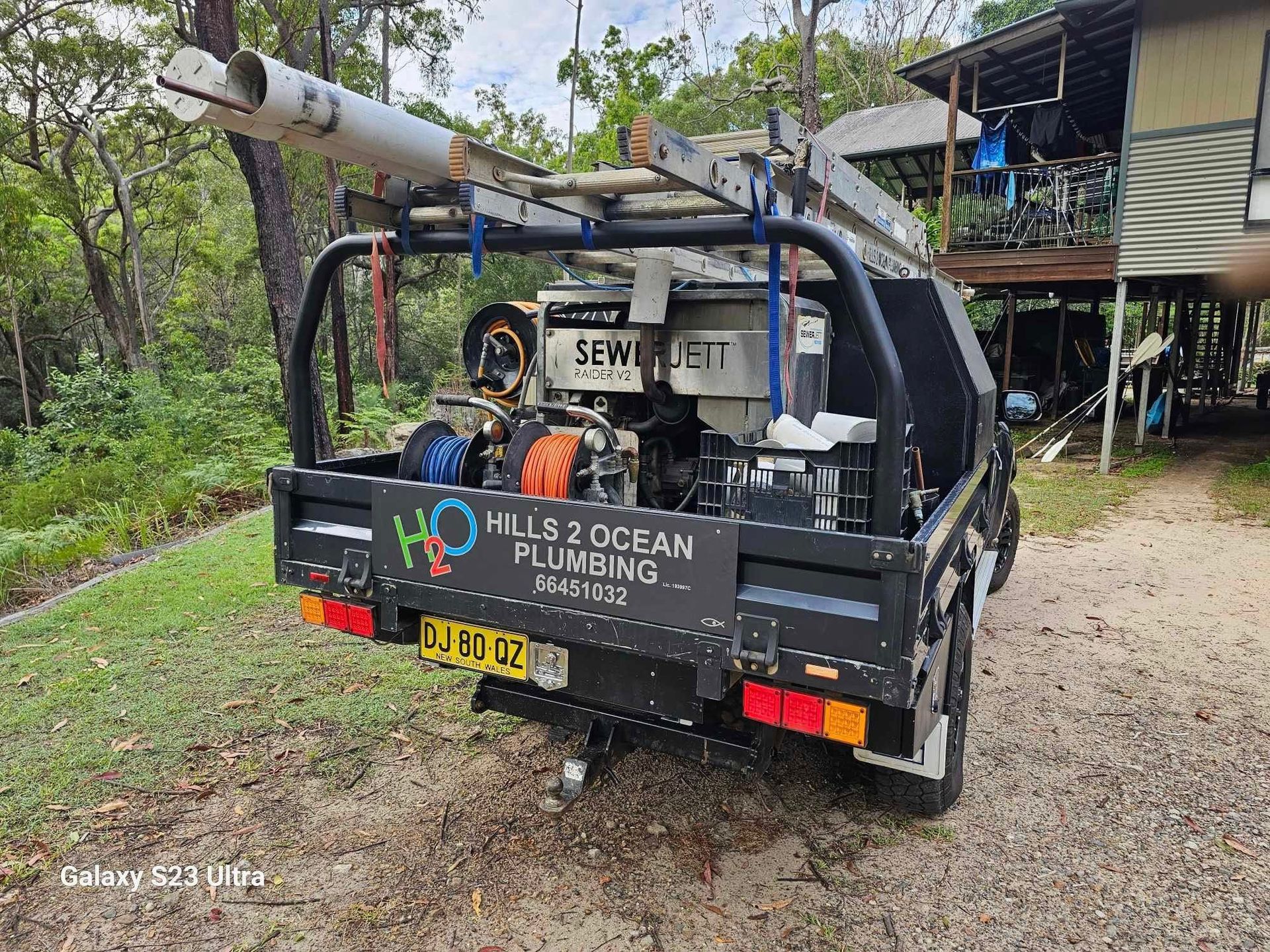 Black Truck With Plumbing Tools Parked Outdoors — Hills 2 Ocean Plumbing in Maclean, NSW