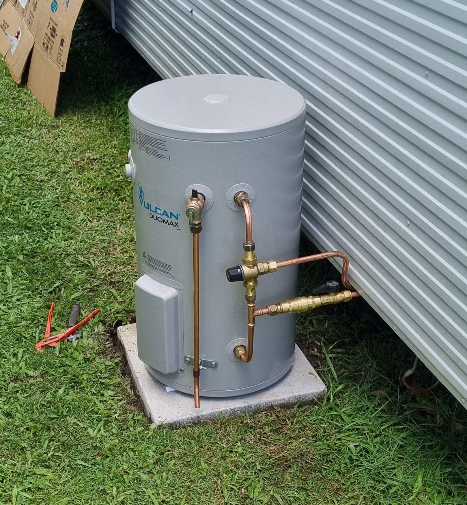 A Grey Water Heater with Copper Pipes Installed Outside — Hills 2 Ocean Plumbing in Maclean, NSW