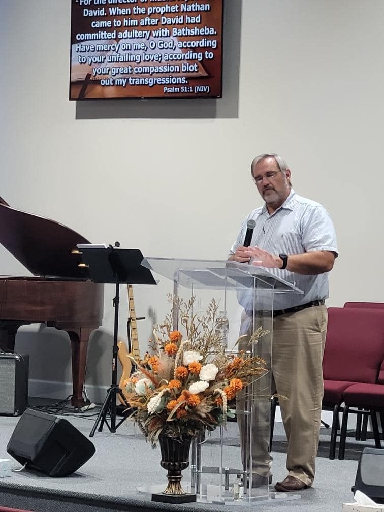 A man is standing at a podium giving a speech