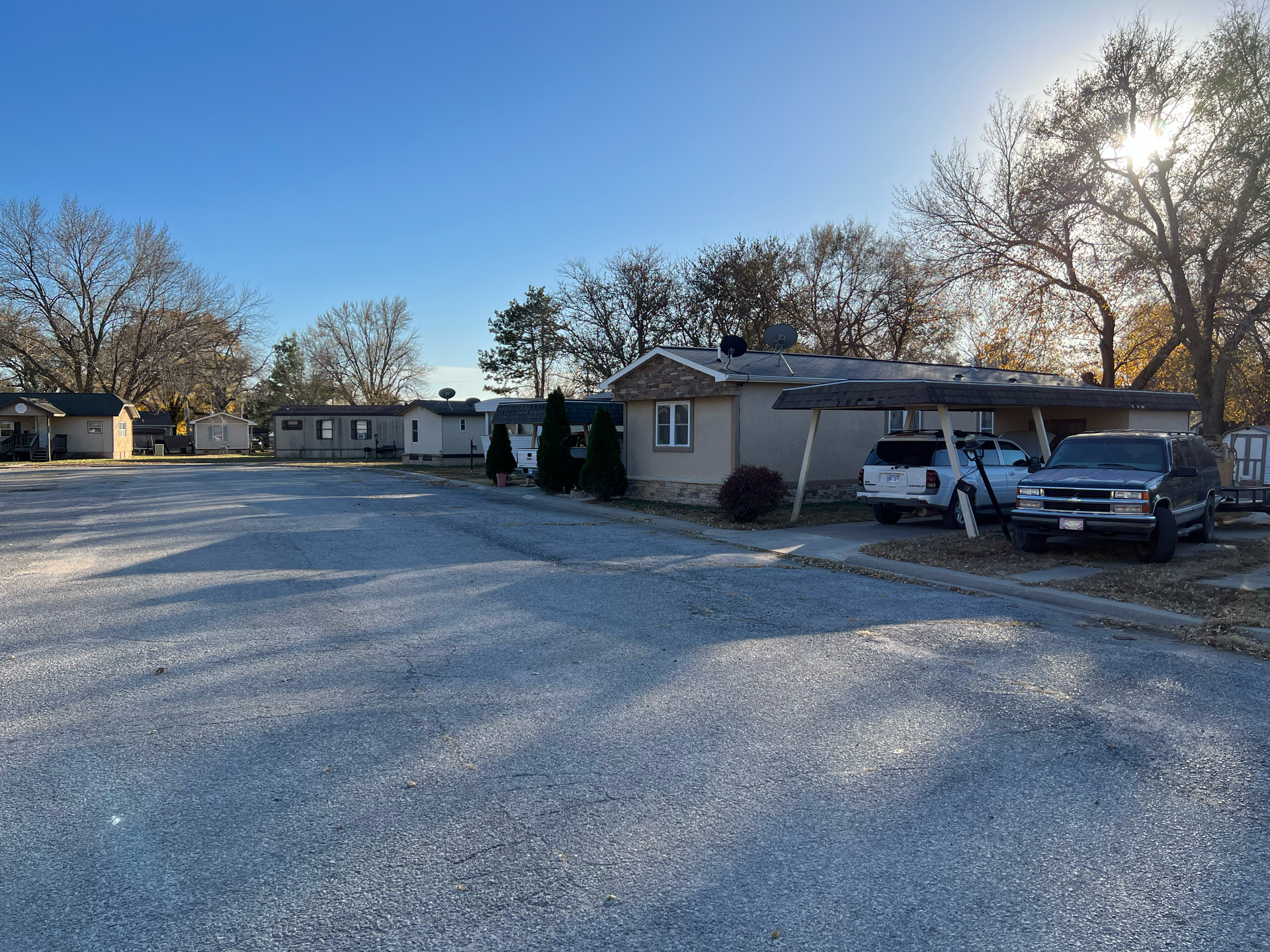 A lot of cars are parked in front of a house
