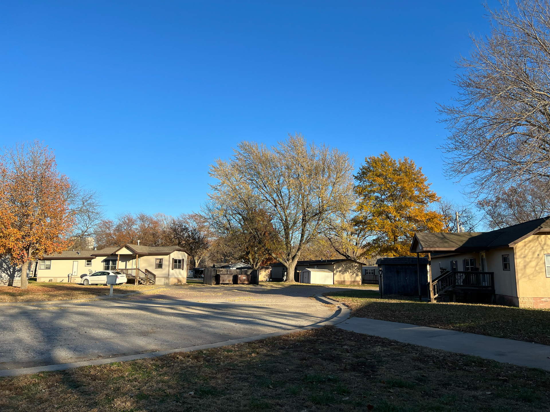 A row of houses in a residential area with a blue sky in the background.