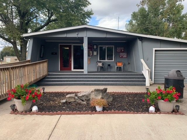 A house with a ramp and flowers in front of it