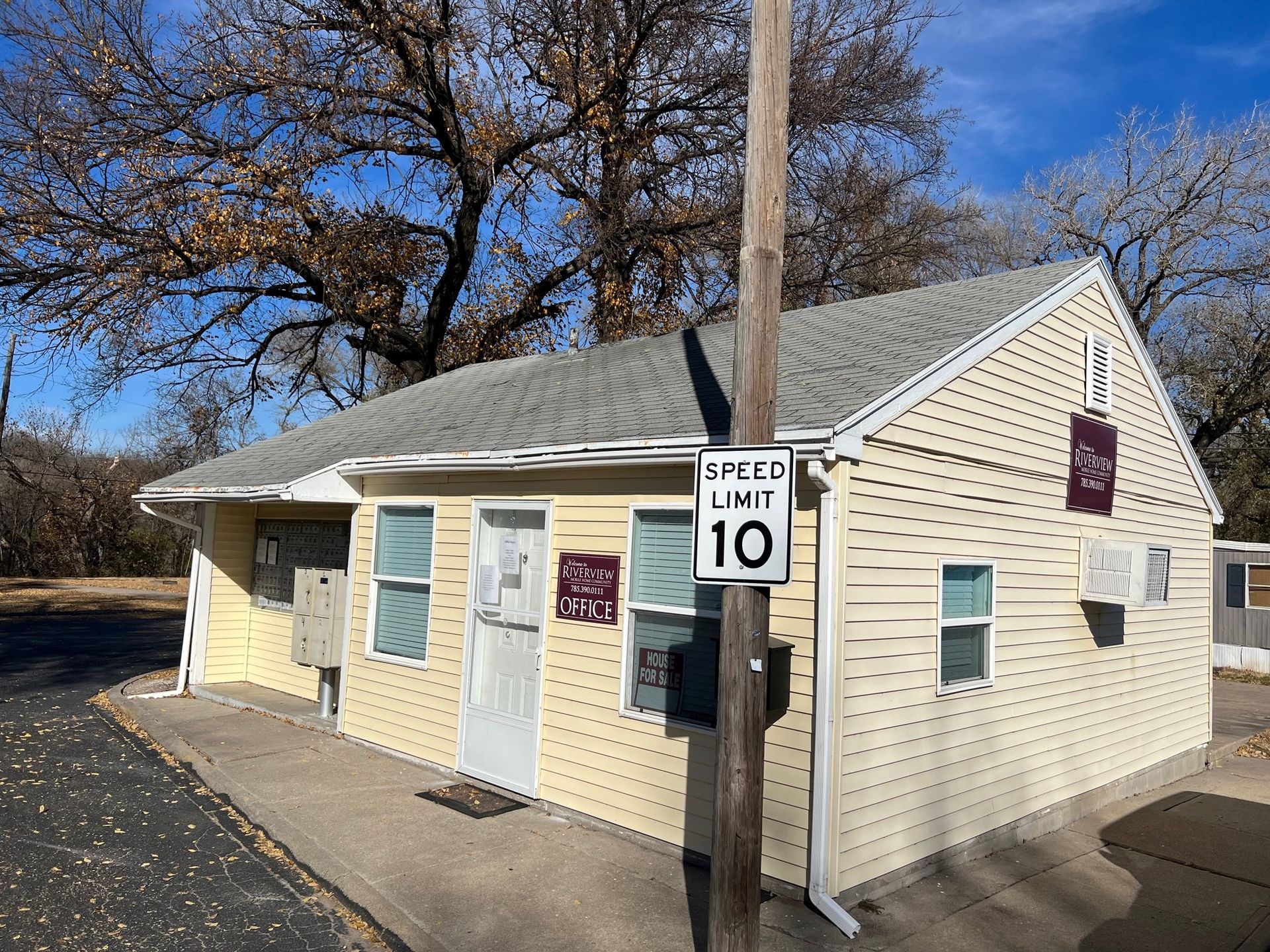 A small house with a speed limit sign on the side of it.