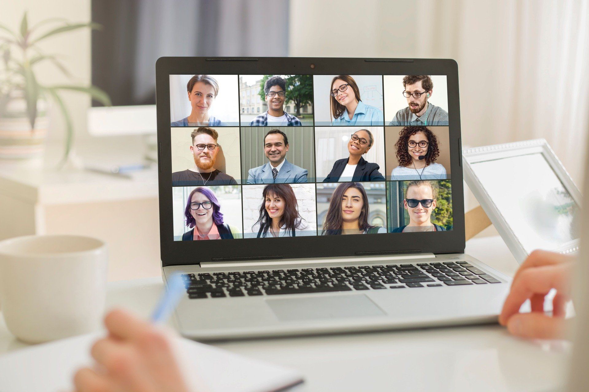 A person is using a laptop computer to have a video call with a group of people.