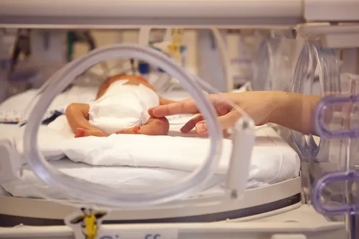 A baby is being cared for in an incubator in a hospital. Friends of Alfie Martin