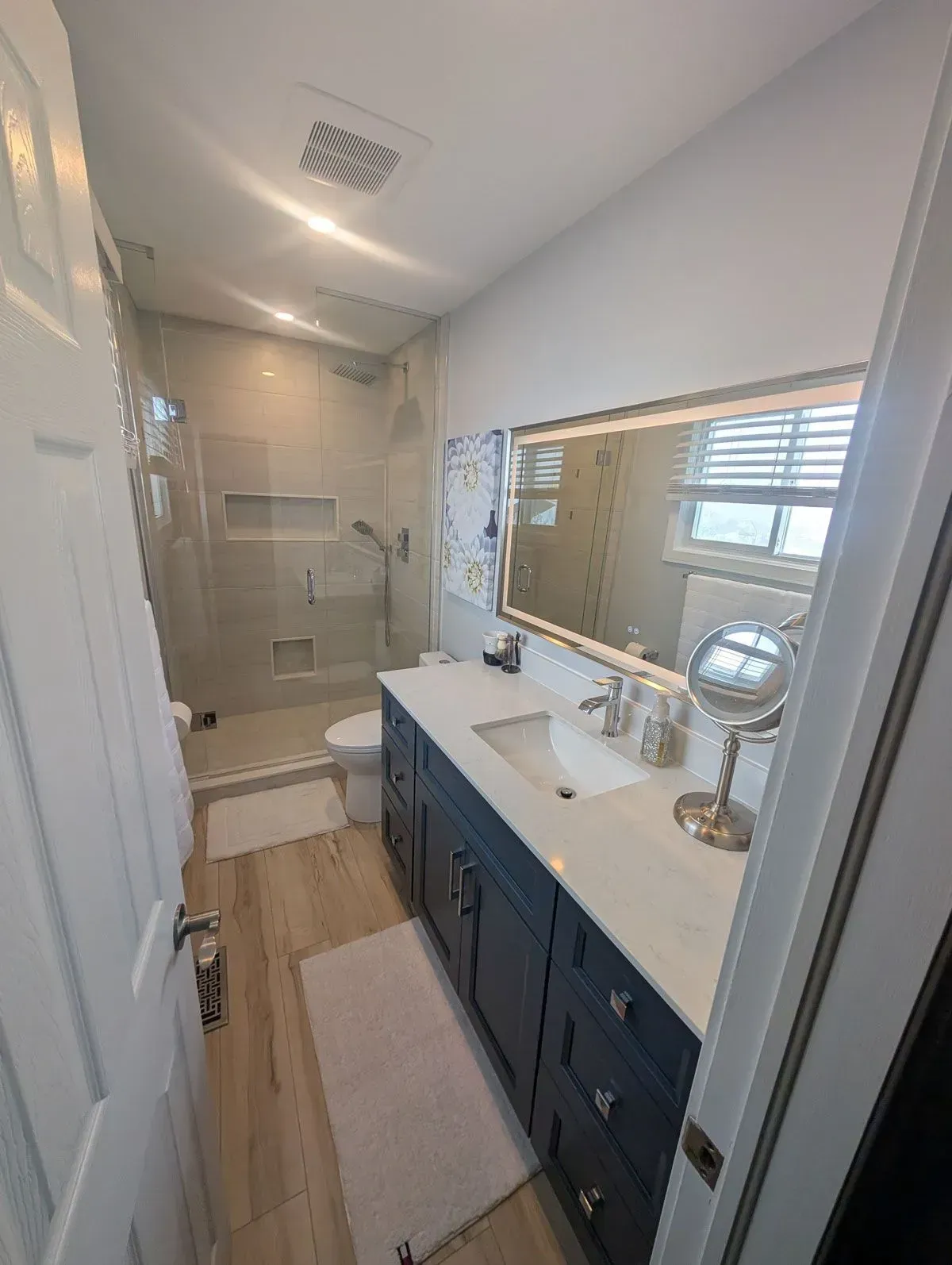 Bright white bathroom renovation with shaker vanity, matte black fixtures and quartz countertop, Stoney Creek Ontario