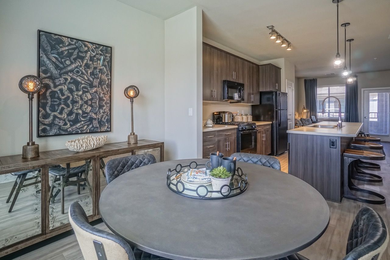 Open-concept kitchen and dining area in a modern apartment.