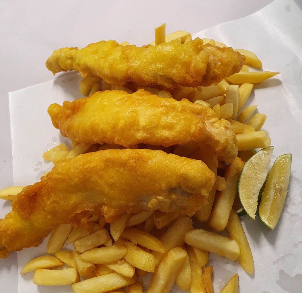 Battered Spanish Mackerel served with fries and lemon — Fish & Chip Shop in Portsmith, QLD