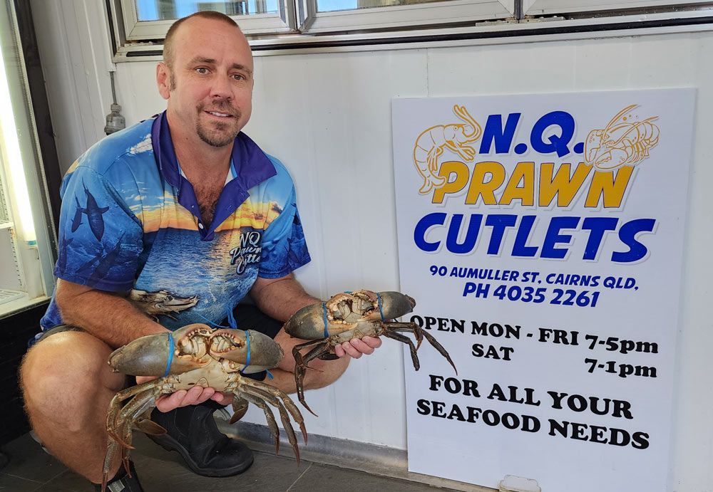 A Man holding Mud Crabs  in his hands— Locally Caught Fresh Mud Crabs in Portsmith, QLD
