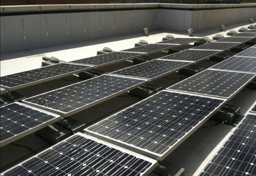 Solar panels installed on a flat roof of a building.