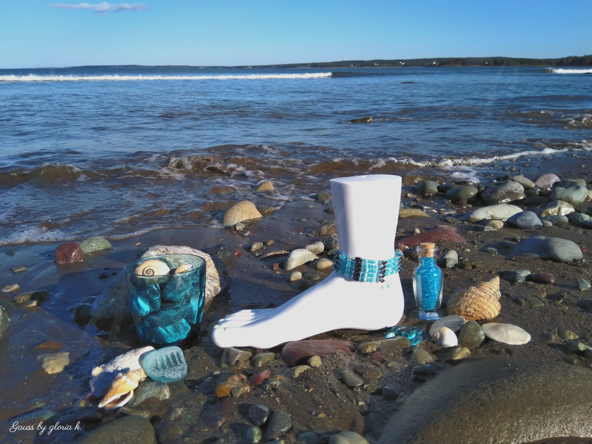 Ocean Blue magnetic hematite wrap anklet with seashells and sea glass on beach