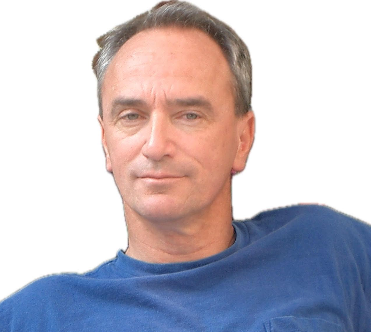 Head-and-shoulders portrait of a person with short brown hair, wearing a blue shirt against a white background.