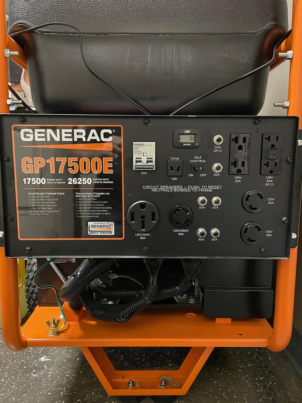 Generac GP17500E portable generator with orange frame, black panel with power outlets and controls.