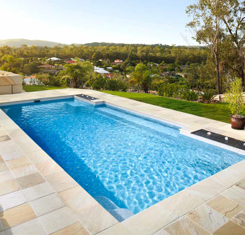 A large swimming pool with a view of a city