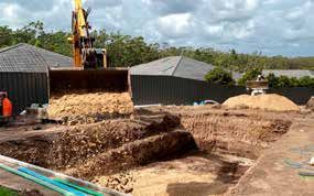 A construction site with a bulldozer and a pile of dirt.