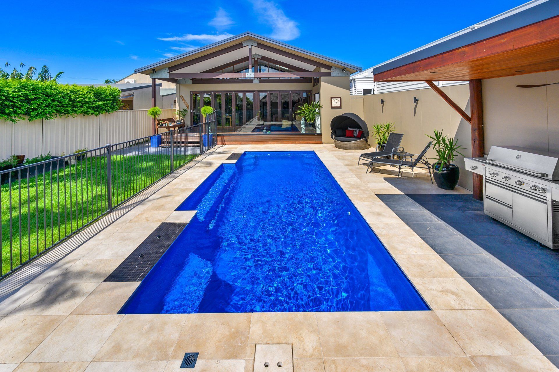 A large swimming pool in the backyard of a house