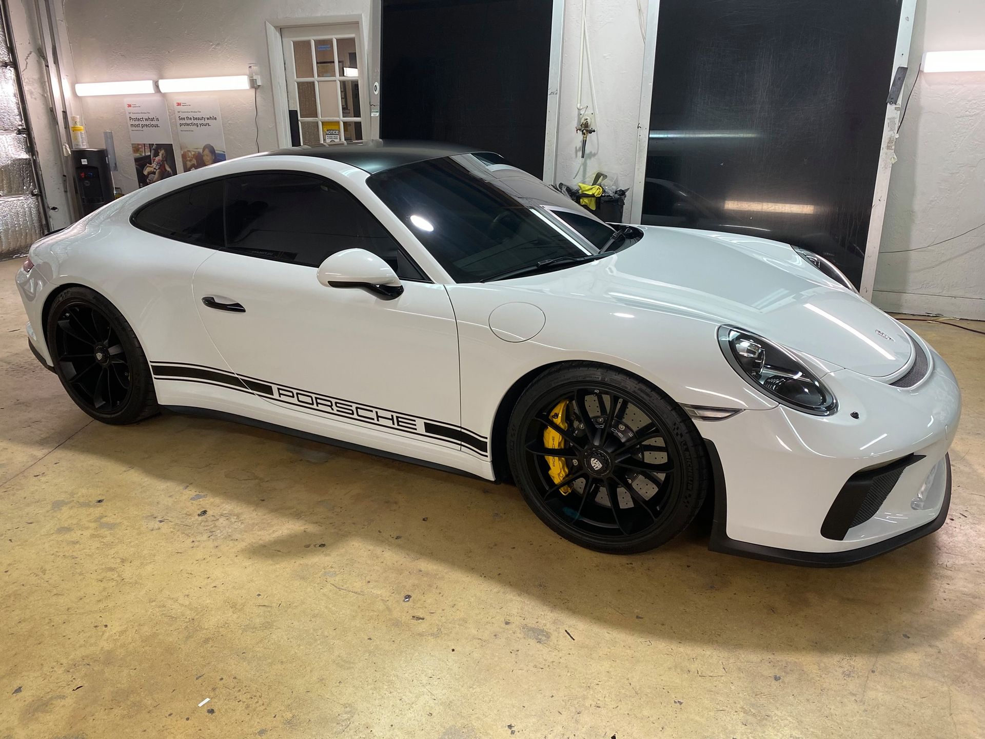 White car with freshly applied Paint Protection Film (PPF) in Miami, FL.