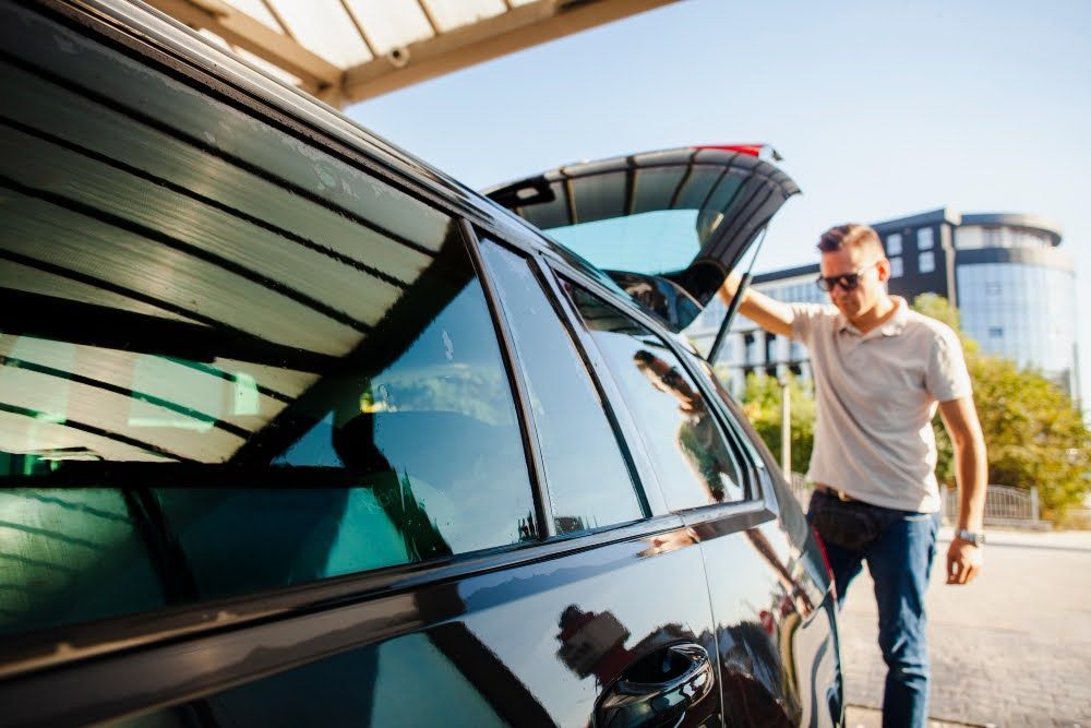 A close-up of a side of a car with ceramic-tinted windows - one of the best ways to keep your car cool in summer