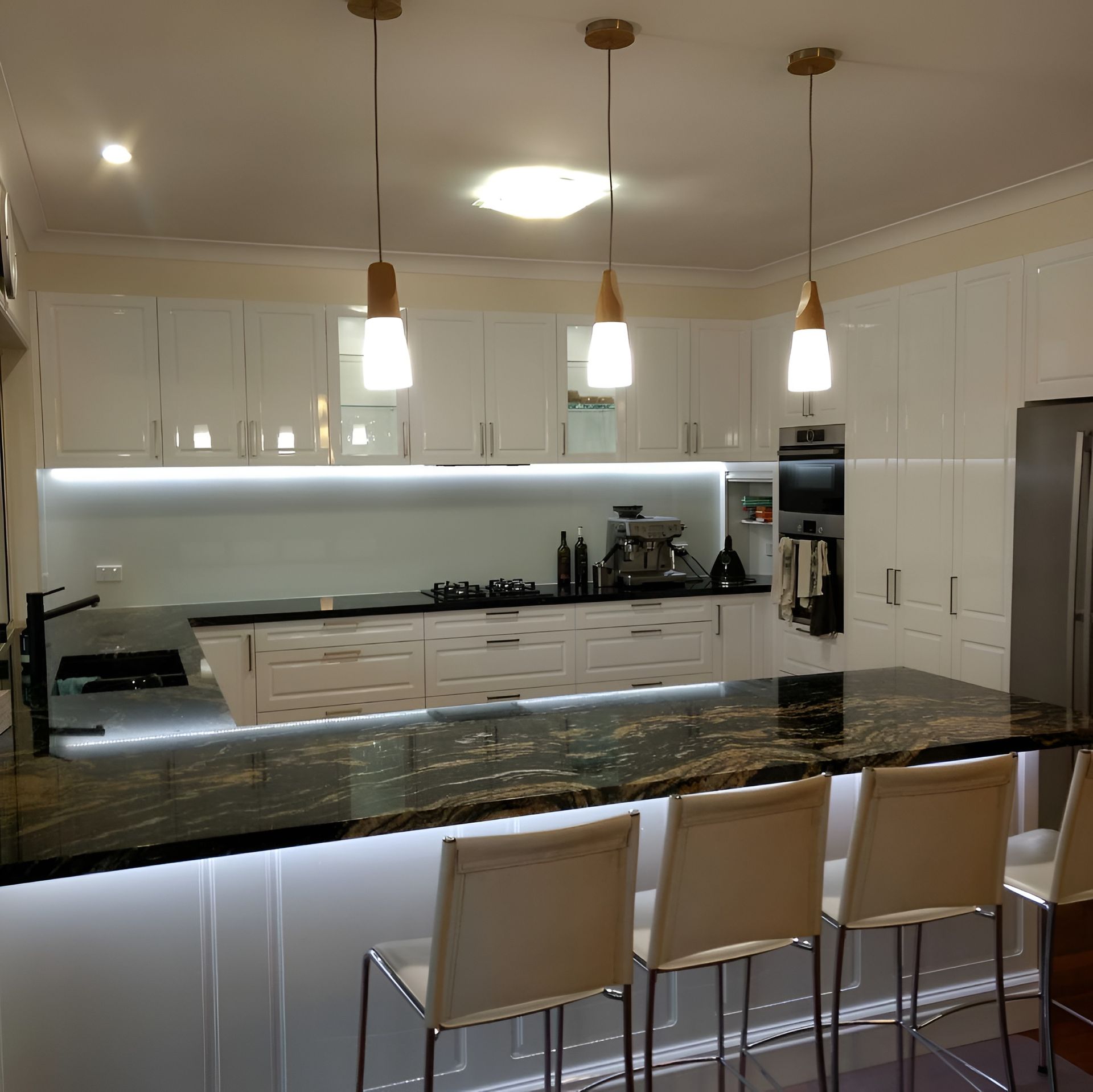 Modern Kitchen With White Cabinets and Granite Island — PK Kitchen Design in West Ipswich, QLD