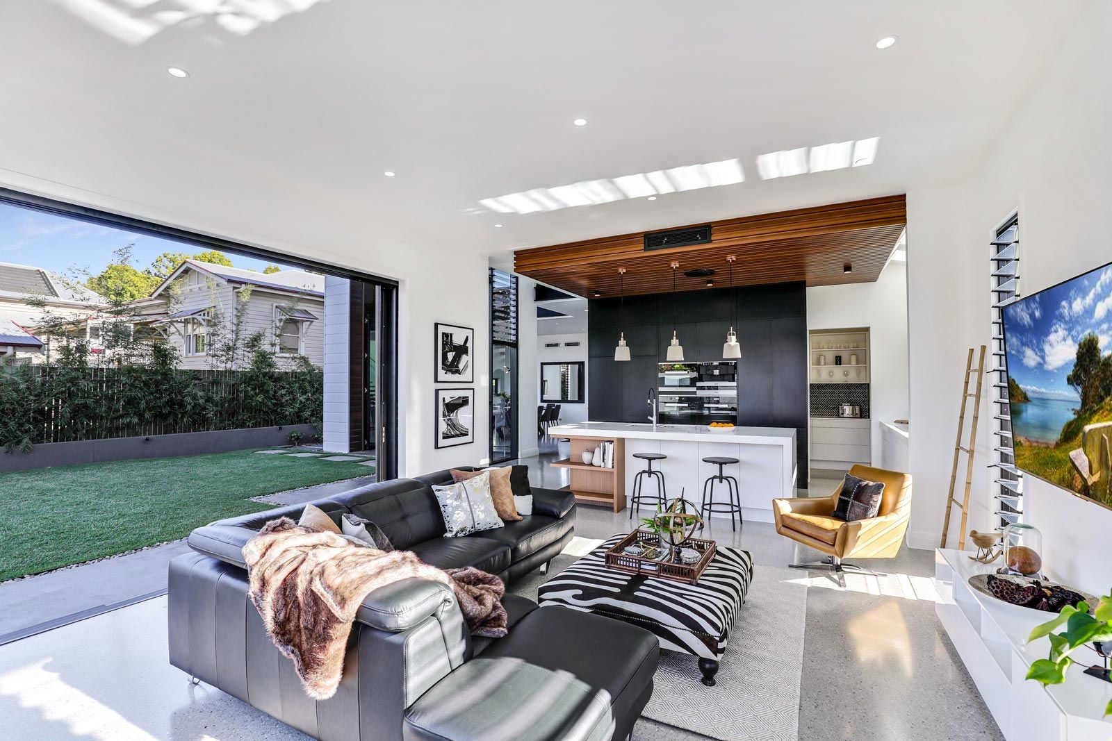 Modern Living Room With Leather Sofa, Open to a Backyard — PK Kitchen Design in West Ipswich, QLD