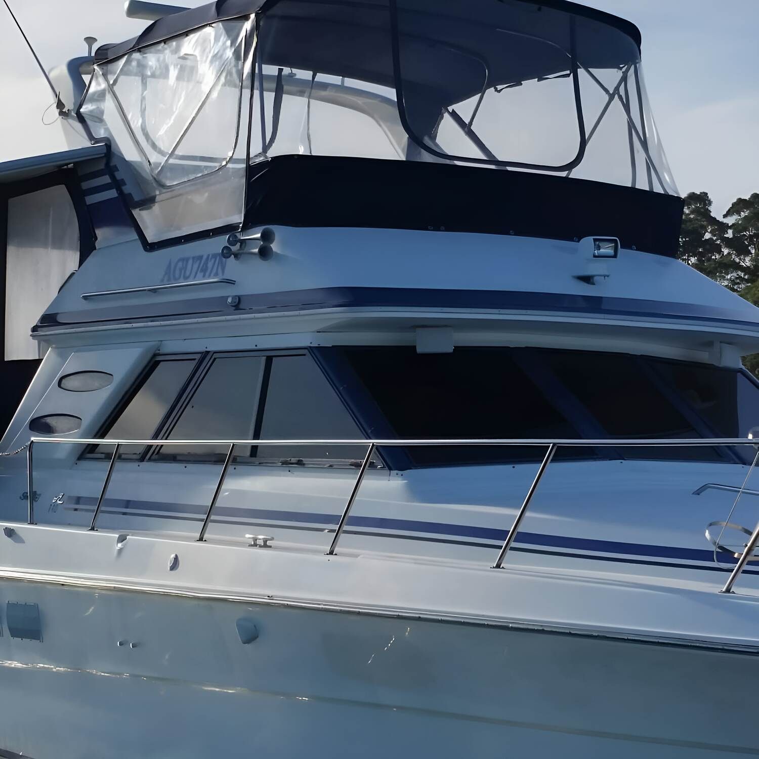 A Boat With A Clear Canopy On Top Of It — Solartint South Coast (Juz Tint) In Batemans Bay, NSW