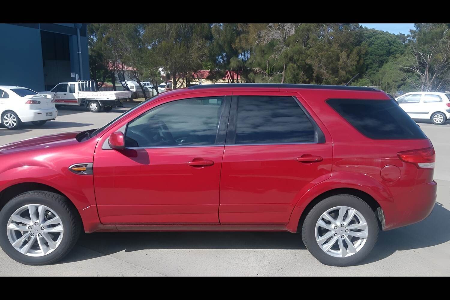 A Red Suv Is Parked In A Parking Lot — Juz Tint In Batemans Bay, NSW