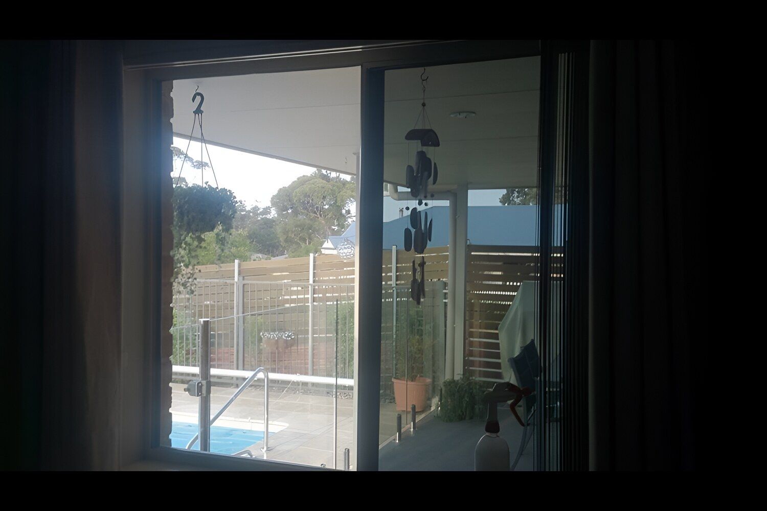 A Room With A Sliding Glass Door Leading To A Pool — Juz Tint In Braidwood, NSW