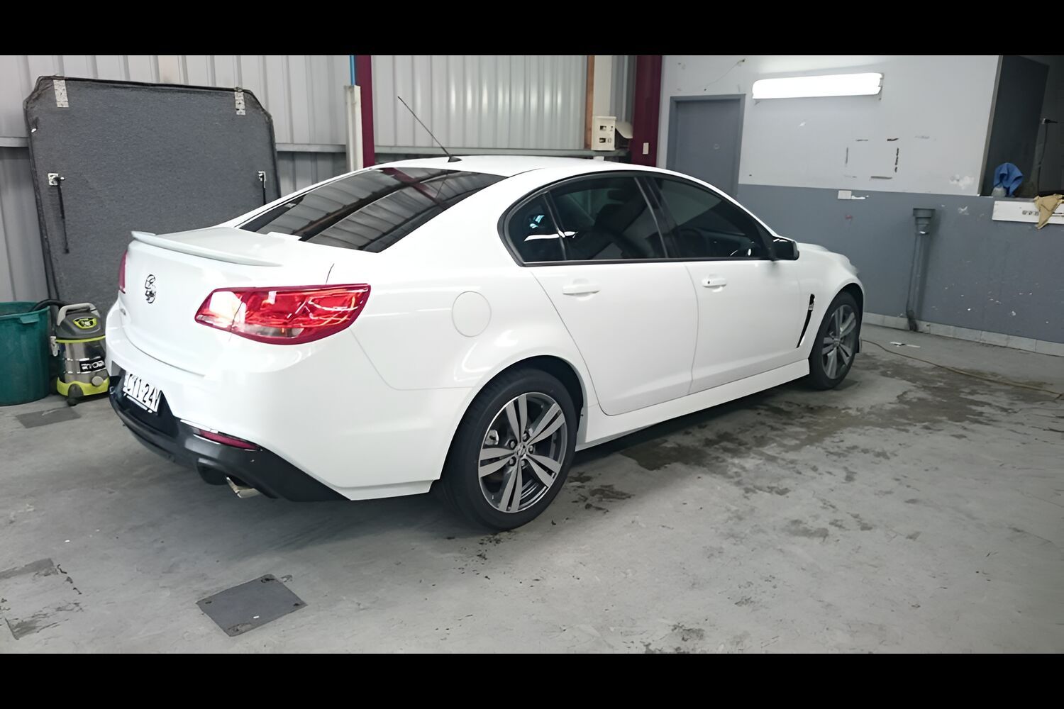 A White Car Is Parked In A Garage — Juz Tint In Ulladulla, NSW