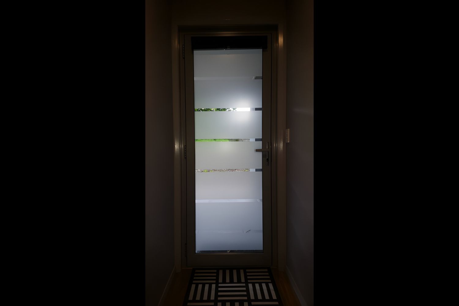 A Door With A Striped Design On It Is In A Hallway — Juz Tint In Ulladulla, NSW