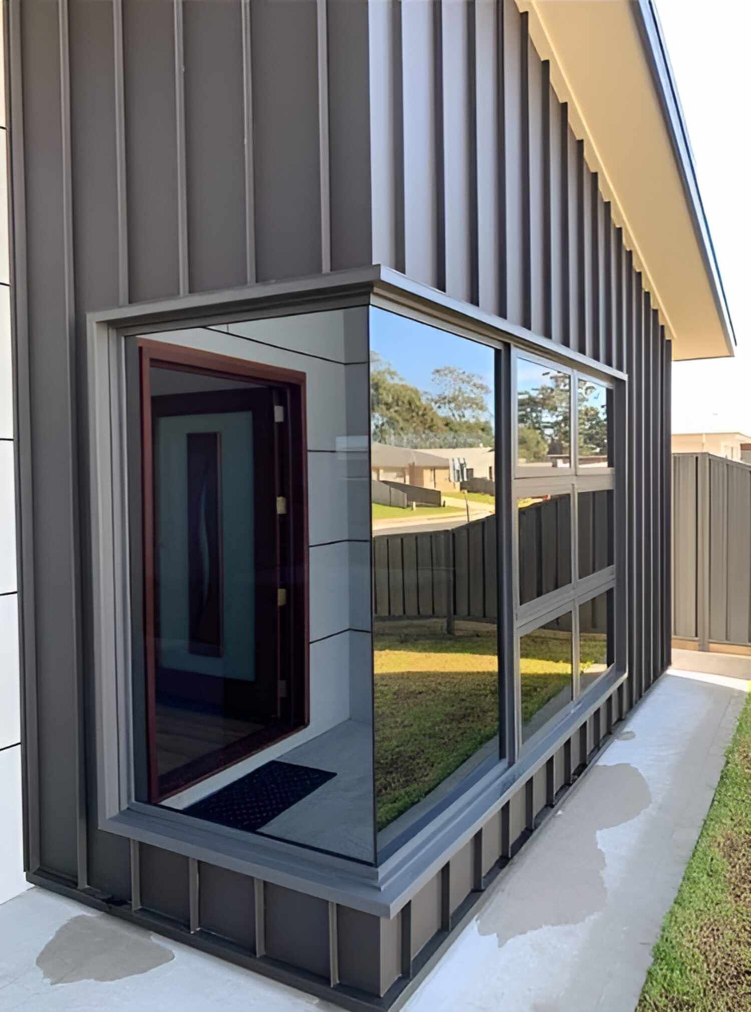 A House With A Large Window On The Side Of It — Solartint South Coast (Juz Tint) In Batemans Bay, NSW