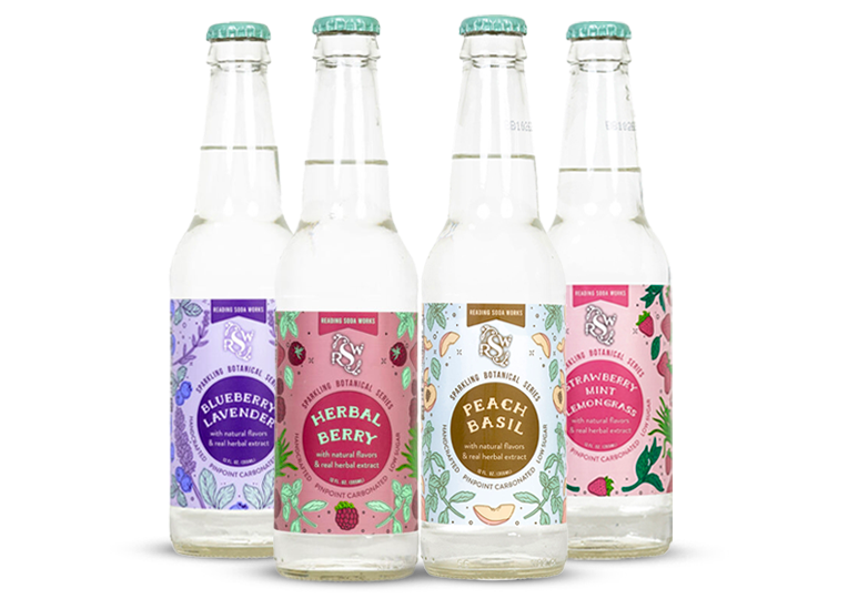 Four colorful bottled beverages with floral labels, arranged in a row on a white background