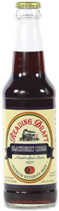 Glass bottle of green’s grocery anise extract with dark liquid and cream label