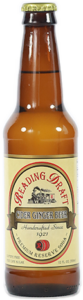 Brown glass beer bottle with a cream label and cap on a white background