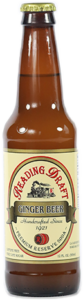 Brown glass bottle of ginger beer with a cream label and gold cap on a white background