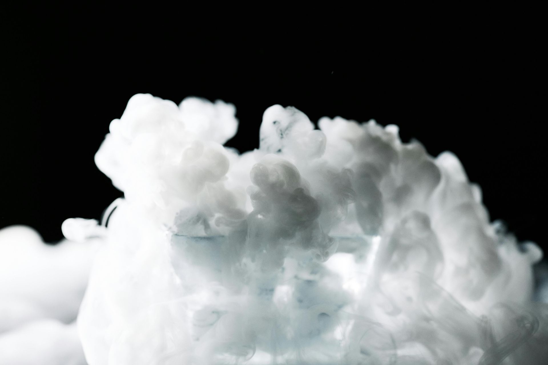 White fluffy clouds against a black background
