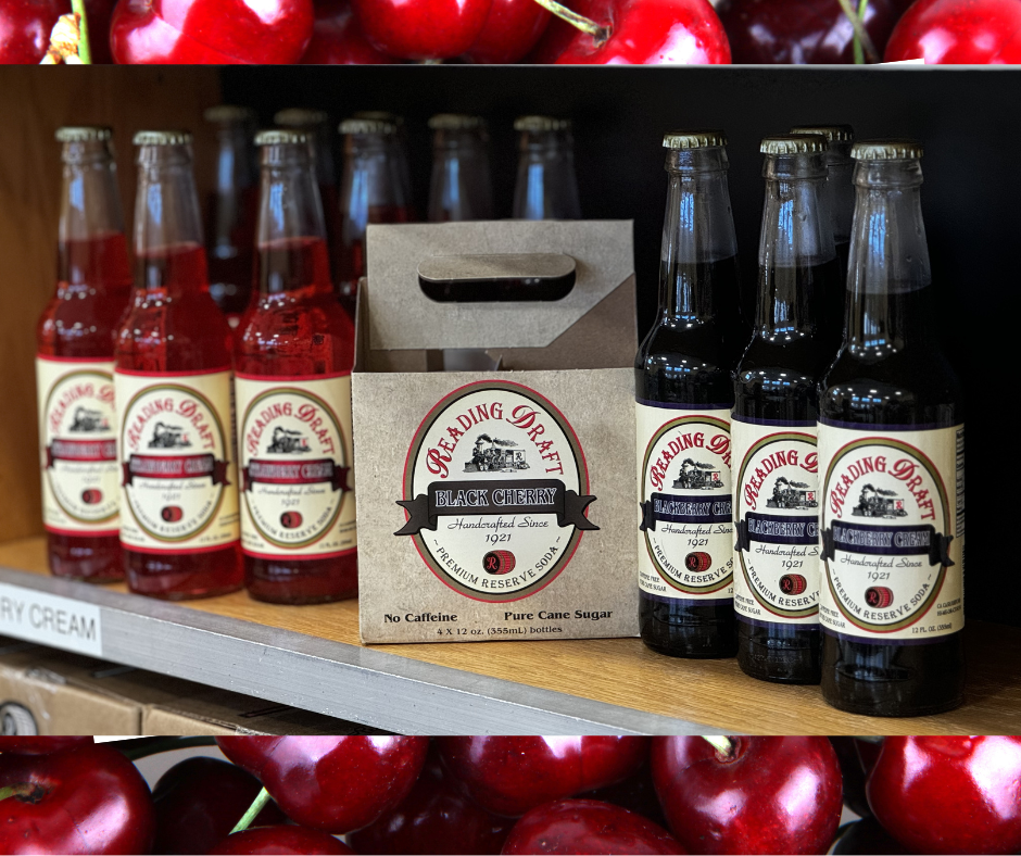 Assorted bottled drinks and a carton of red beverages on a store shelf with apples in the foreground