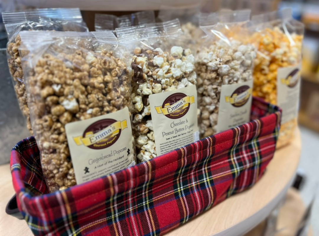 Bagged popcorn in a red plaid basket display on a table